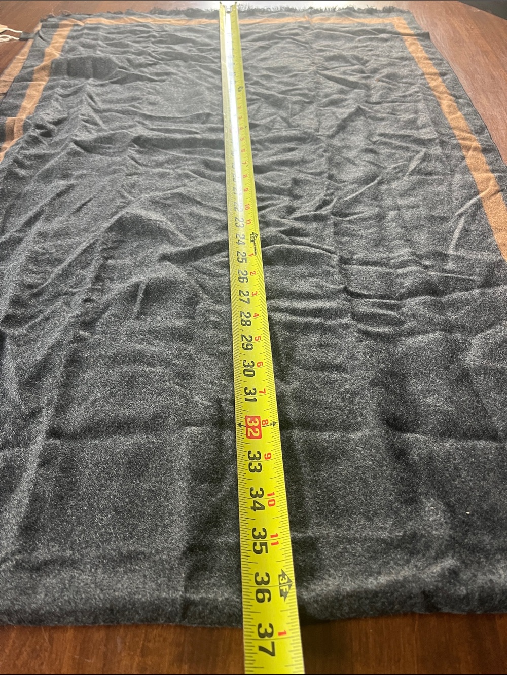 Melifluos Cale in Carcoal and with Brown Trim can be worn as a Shawl or Cape